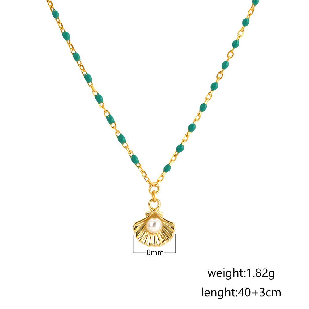 sterling silver necklace with round natural pearl shell and green epoxy pendant on white background