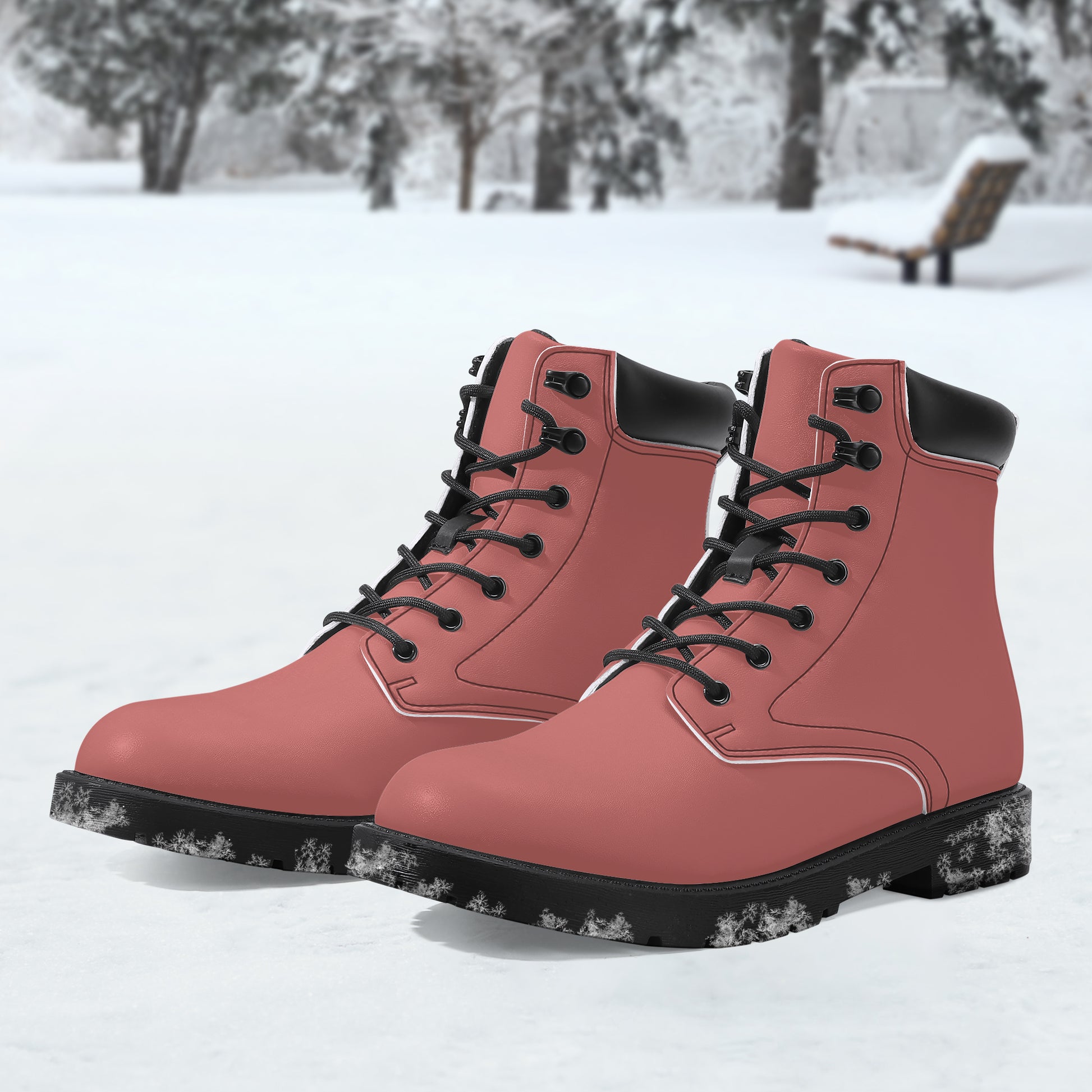 Pink boots with black soles on a snowy background
