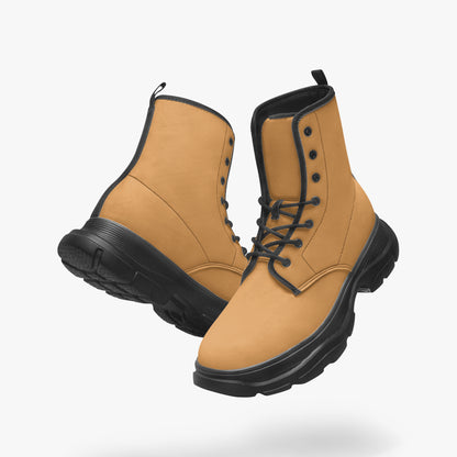 Pair of tan work boots with black soles on a white background