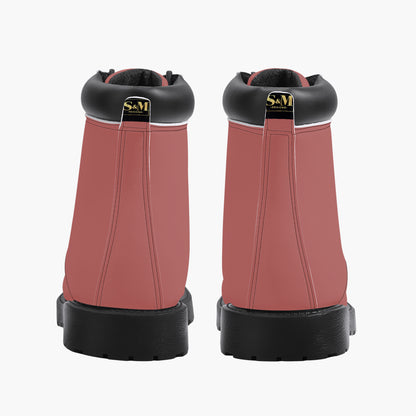 Pair of pink boots with black soles and collars on a white background