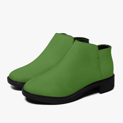 Green ankle boots with black soles on a white background
