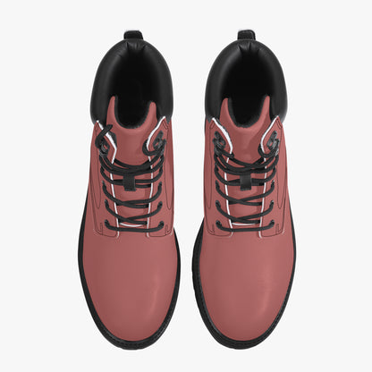 Pair of pink boots with black soles and laces on a white background