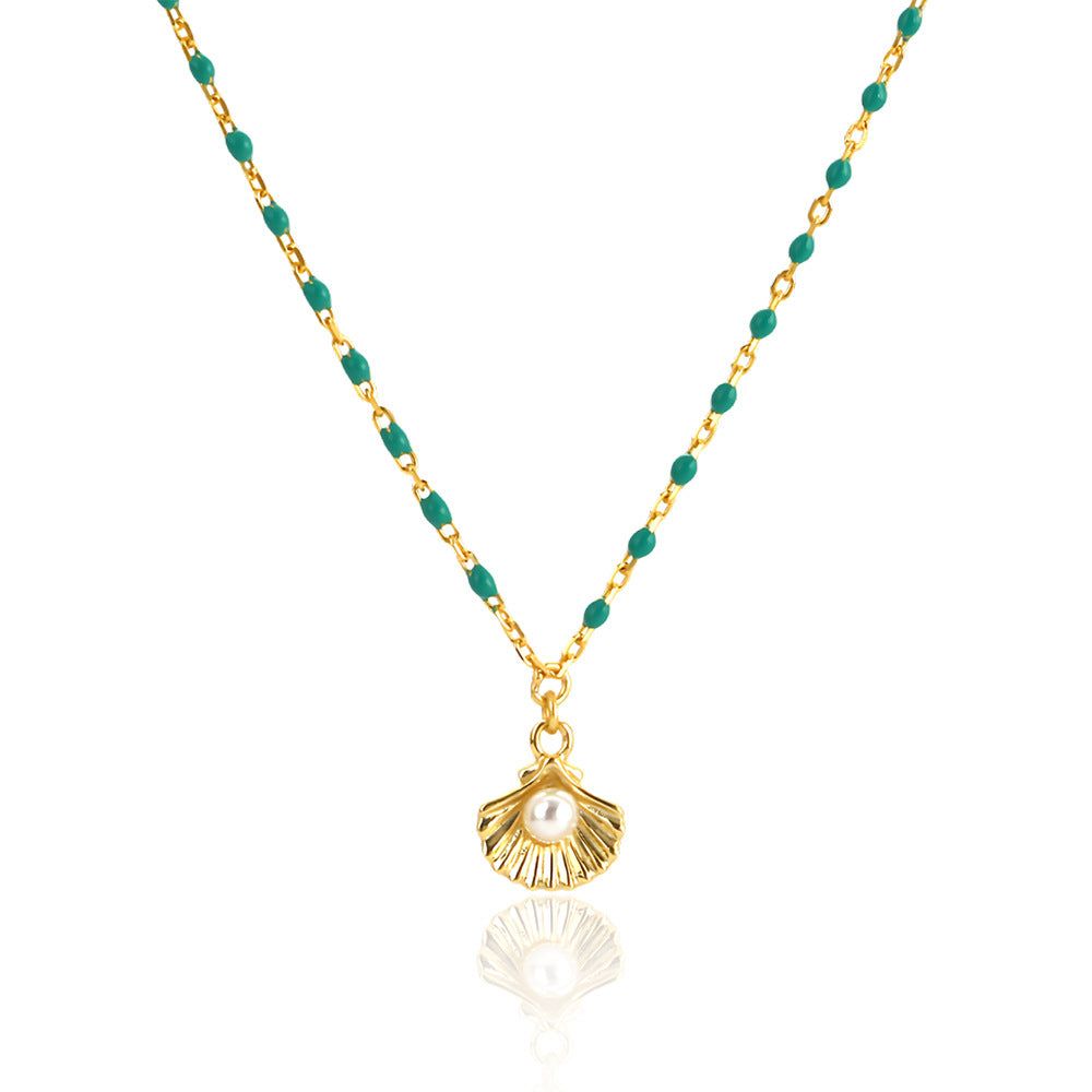 925 sterling silver necklace with round natural pearl shell and green epoxy pendant on white background