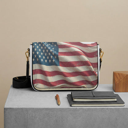 Saddle bag with American flag design on a gray surface with a beige background