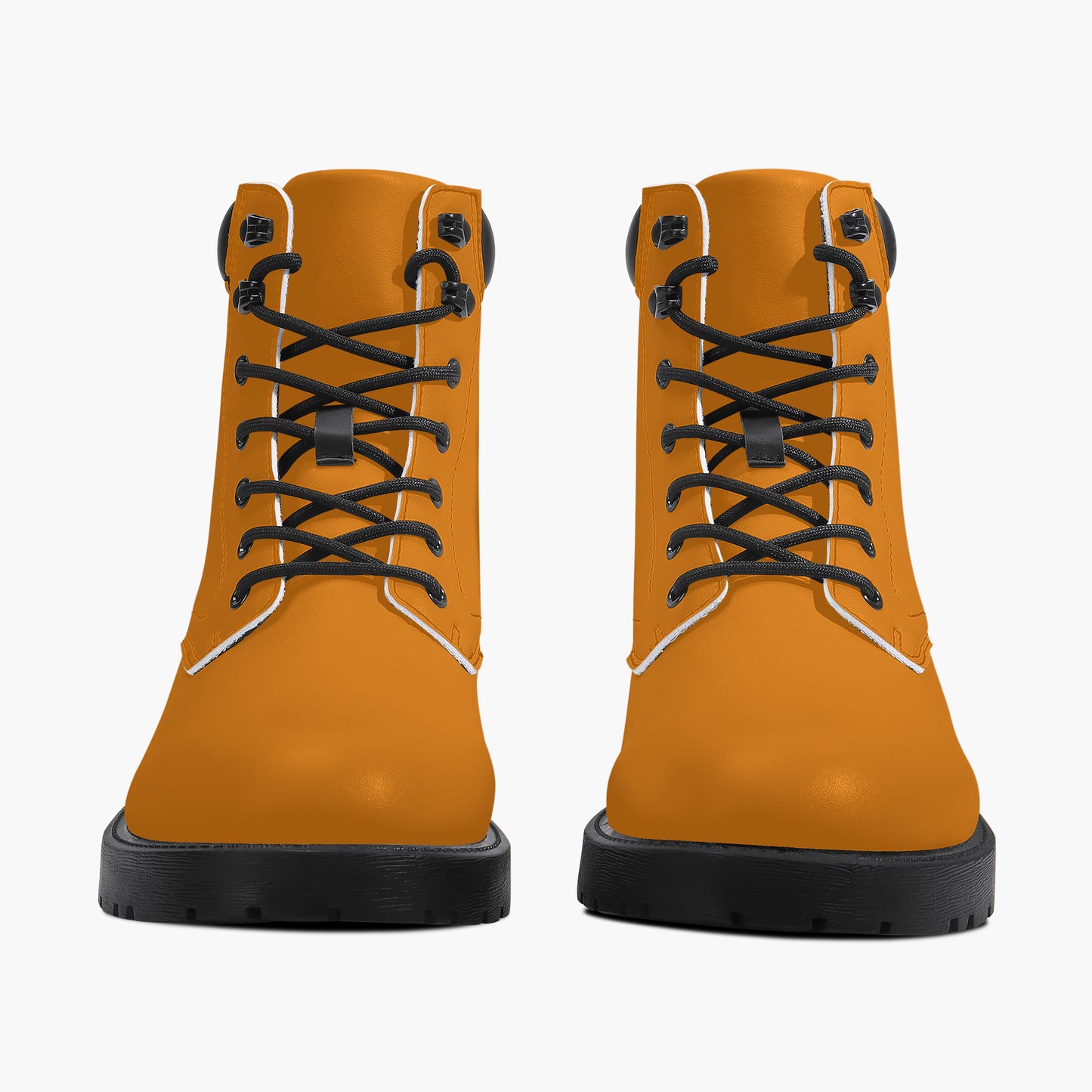 Pair of orange boots with black laces on a white background