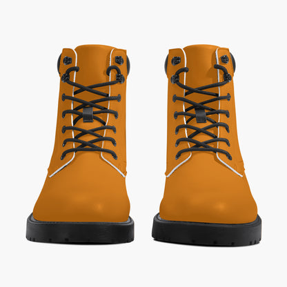 Pair of orange boots with black laces on a white background
