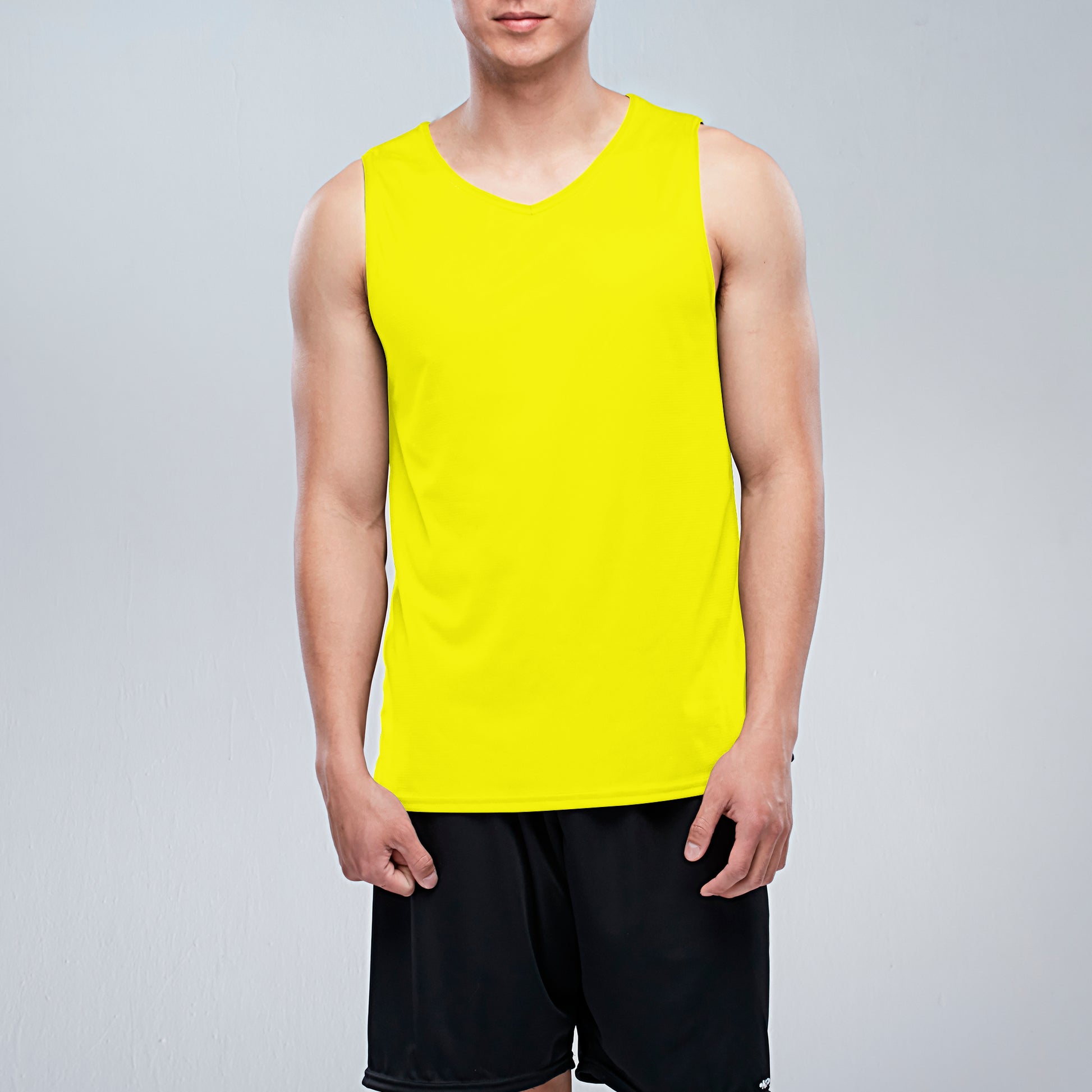 Person wearing a bright yellow sleeveless shirt on a light gray background, Tank Top