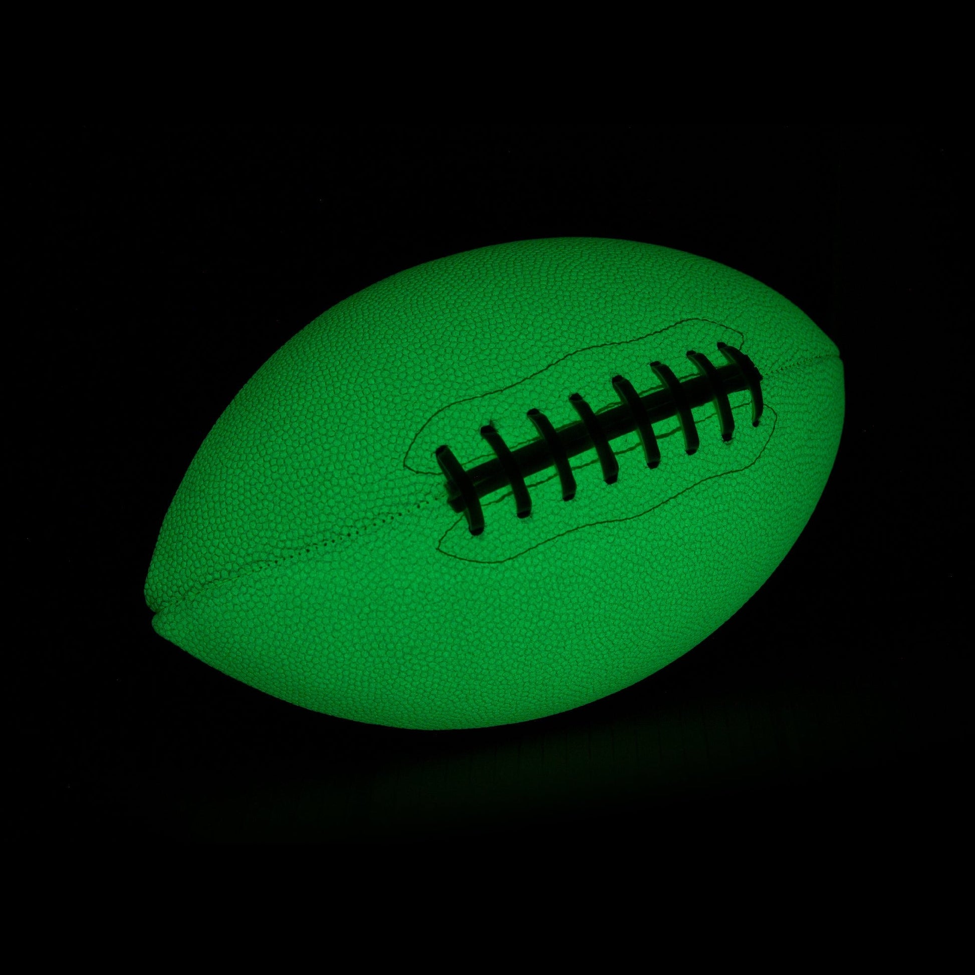 Glow In The Dark football with black stitching on a black background