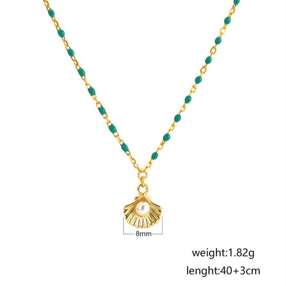 sterling silver necklace with round natural pearl shell and green epoxy pendant on white background