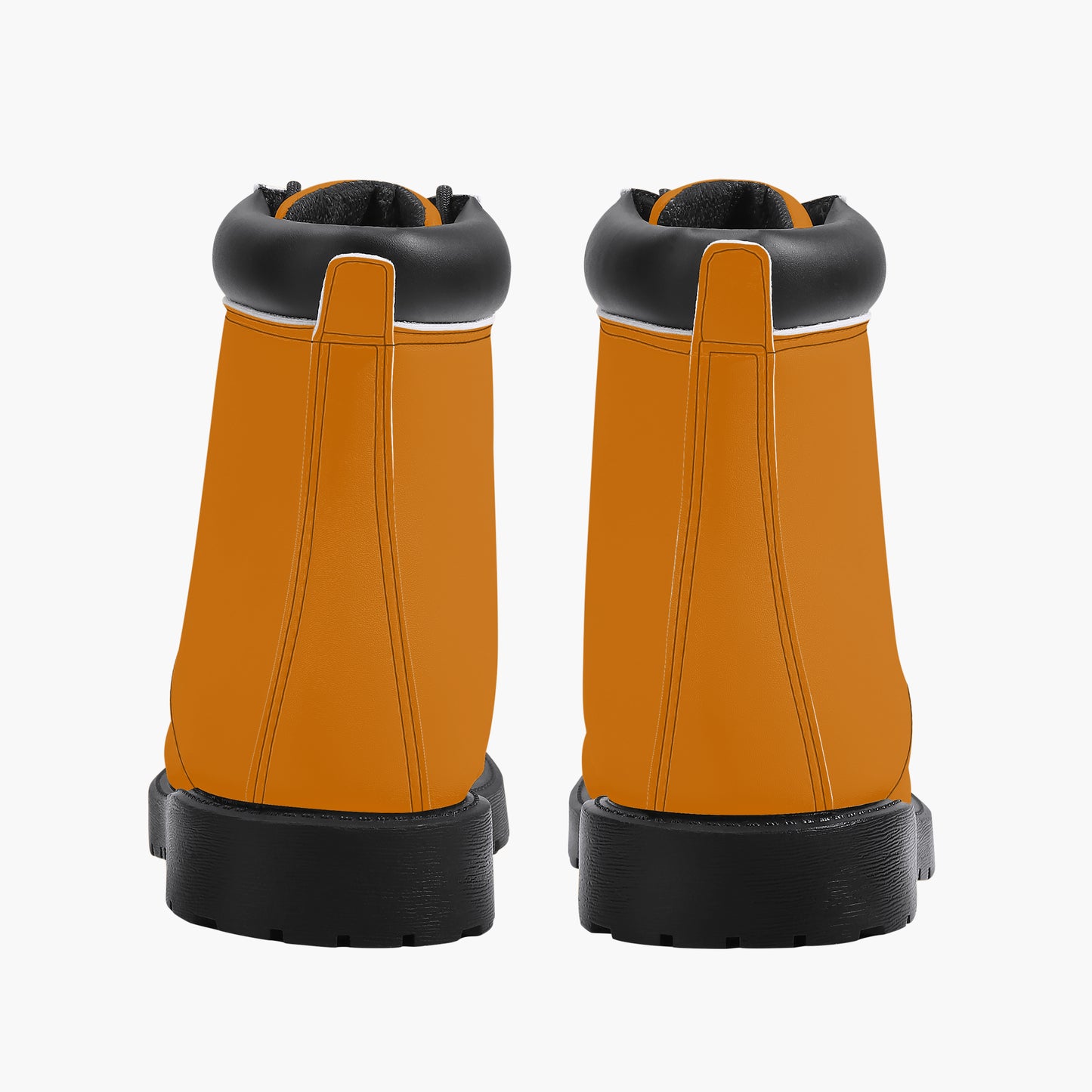Pair of orange work boots with black soles on a white background