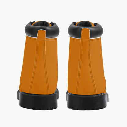 Pair of orange work boots with black soles on a white background