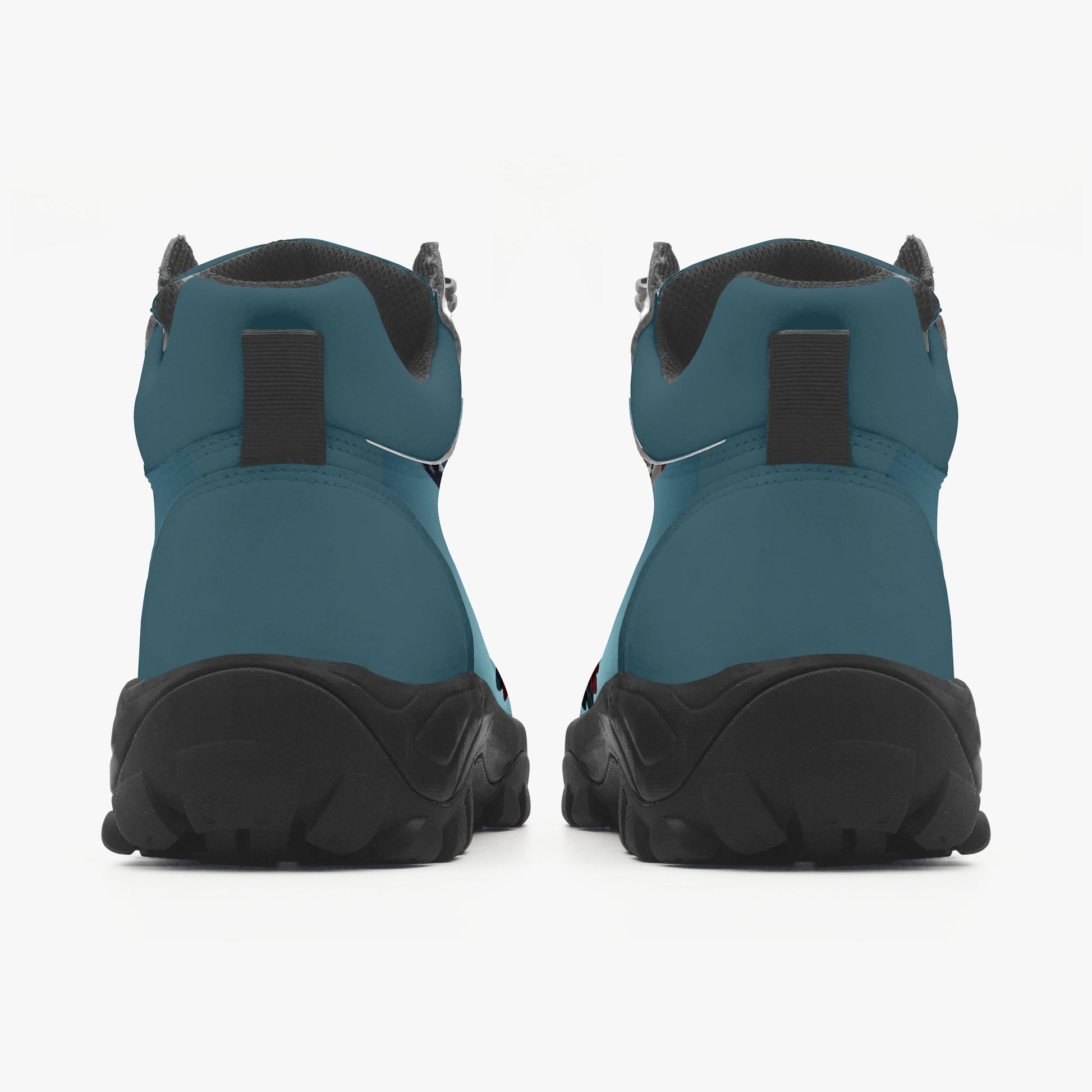 Pair of teal and black boots on a white background