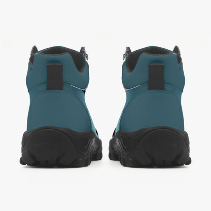 Pair of teal and black boots on a white background