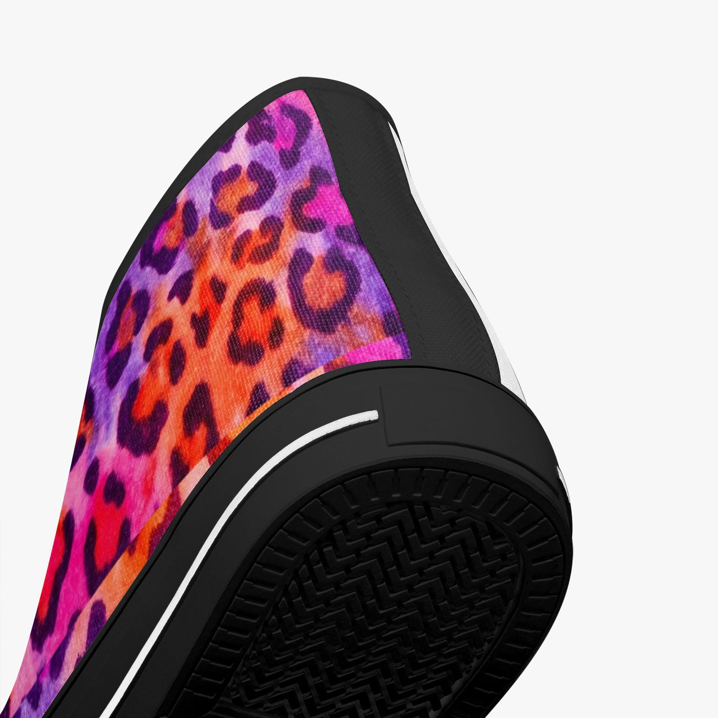 Close-up of a slip-on shoe with a colorful leopard print on a white background